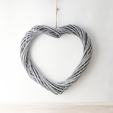 An large sized woven wicker heart hung from jute string, make your own by adding lights and foliage 