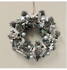 A large decorative wooden wreath with added bold silver tones and festive accents 
