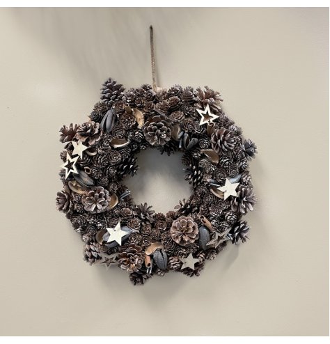 A beautifully rustic wreath with wooden stars, pinecones and added foliages to set the look 