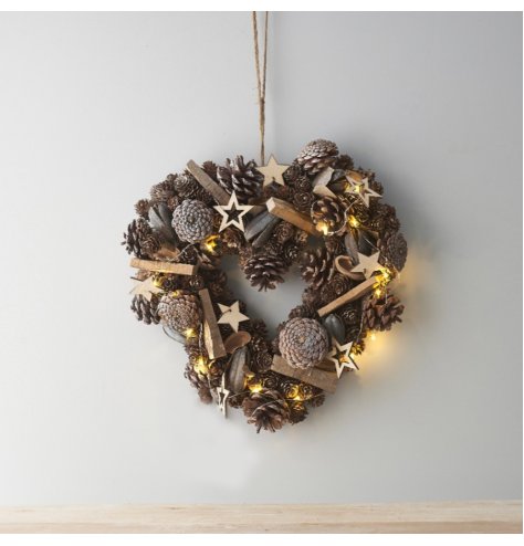 A beautifully rustic wreath with wooden stars, pinecones and added foliages to set the look. Dazzled with added warm whi