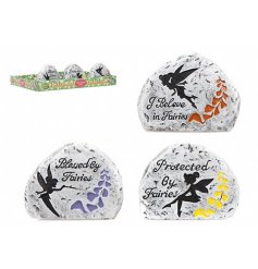 An assortment of small rocks, each embossed with a printed fairy quote and charming decal 
