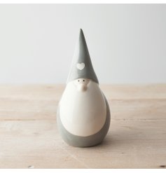 A grey toned ceramic gonk figure with a plump look and sweet heart decal to complete his look 