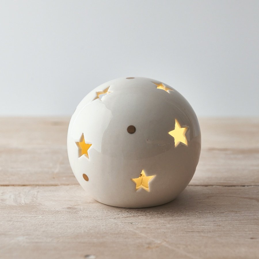  A small and simple rounded ceramic ball set with star cut details and added gold dots 