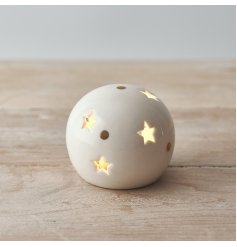 A small and simple rounded ceramic ball set with star cut details and added gold dots 