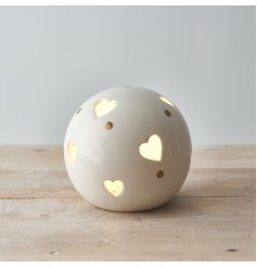  A small and simple rounded ceramic ball set with heart cut details and added gold dots 