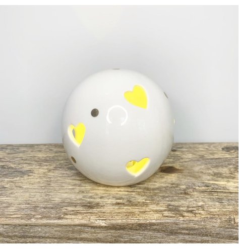 A ceramic ball with heart cut decals, gold dots features and a warm glowing LED centre 
