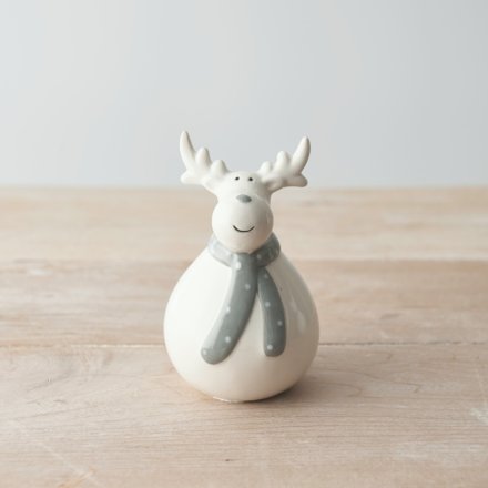   An adorable white toned ceramic reindeer with a plump body and festive grey scarf 