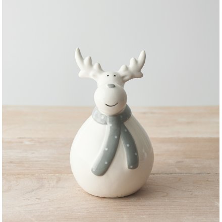  An adorable white toned ceramic reindeer with a plump body and festive grey scarf 