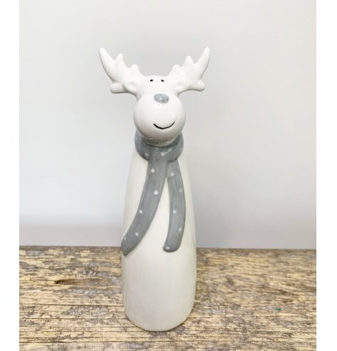 A charming and simple ceramic reindeer character dressed up in a grey dotted scarf 