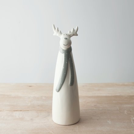  A tall ceramic reindeer complete with a long grey scarf and simplistic charm 