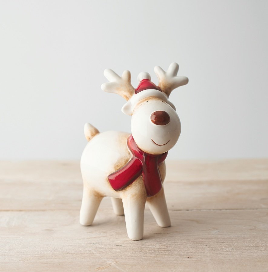  A sweet standing ceramic reindeer with neutral colour tones and a red nose to complete his look 