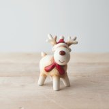 A sweet and simple white reindeer with a red nose, a charming character decoration to place in the home 