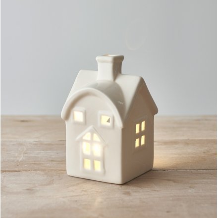 A chic and simple white toned house with only an added heart cut decal and t-light holder option 