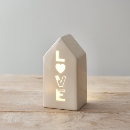 A ceramic house t-light holder with a love cut out decal complete with a LED candle