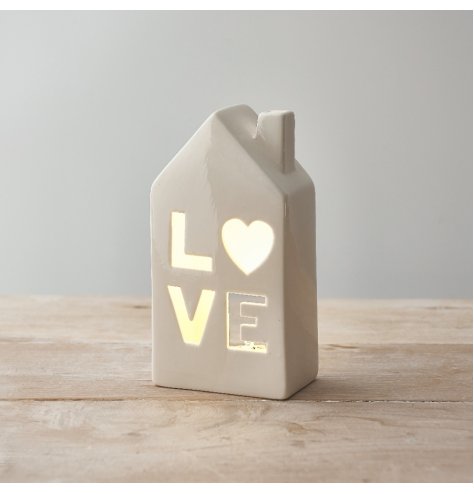 A beautiful ceramic home t-light holder with a 'love' cut decal. 