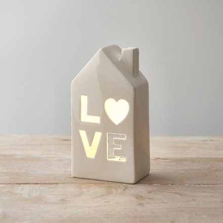 A beautiful ceramic home t-light holder with a 'love' cut decal. 