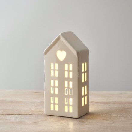 A chic and simple ceramic white house with an heart cut decal and LED lights