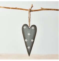 A simple inspired hanging ceramic heart in a rustic grey tone and complete with a starry print 