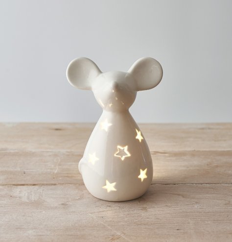 A sweet and simple mouse shaped tlight holder with a star cut decal and sleek white tone  
