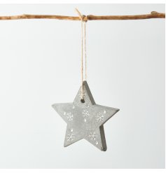 A small distressed concrete star hanging decoration set with white embossed snowflakes and dots 