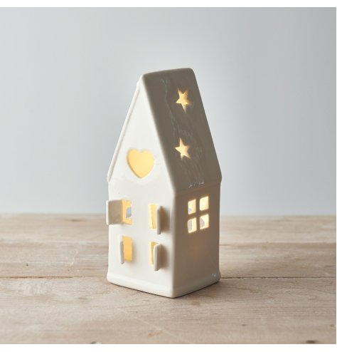 A wonderfully simplistic white ceramic house t-light holder, finished with cut out windows, doors and a small dainty sta