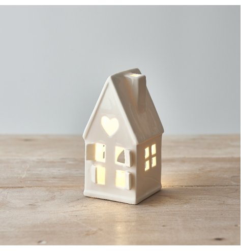 A wonderfully simplistic white ceramic house t-light holder, finished with cut out windows, doors and a small dainty sta