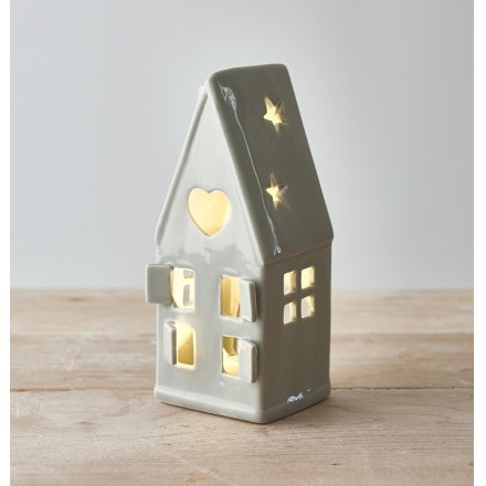 A wonderfully simplistic grey ceramic house t-light holder, finished with cut out windows, doors and a small dainty star