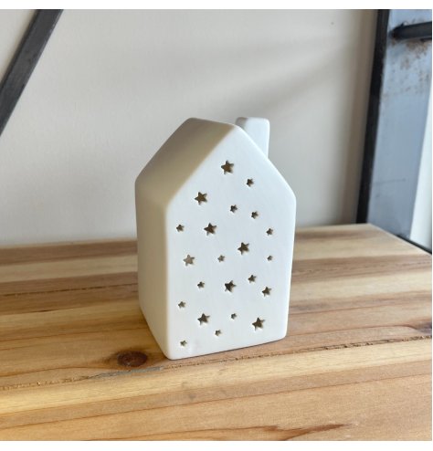 A chic and stylish star cut ceramic house complete t-light holder