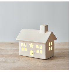 A charmingly simple ceramic house decoration complete with a warm glowing LED centre 