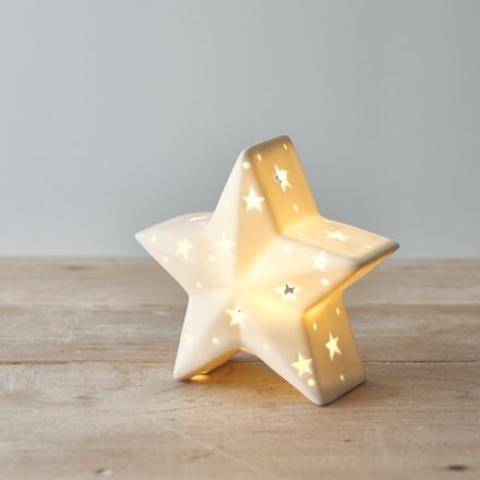 A chic and simple ceramic star decoration complete with a warm glowing LED centre and small star cut features