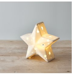 A chic and simple ceramic star decoration complete with a warm glowing LED centre and small star cut features