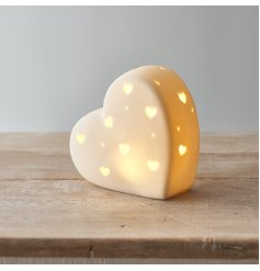 A chic and simple ceramic heart decoration complete with a warm glowing LED centre and small heart cut features