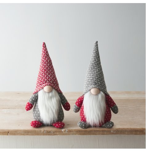 An assortment of 2 nordic grey, red and white sitting gonk decorations. Each has faux fur trims, patterned decals and ta