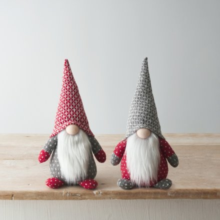 An assortment of 2 nordic grey, red and white sitting gonk decorations. Each has faux fur trims, patterned decals and ta