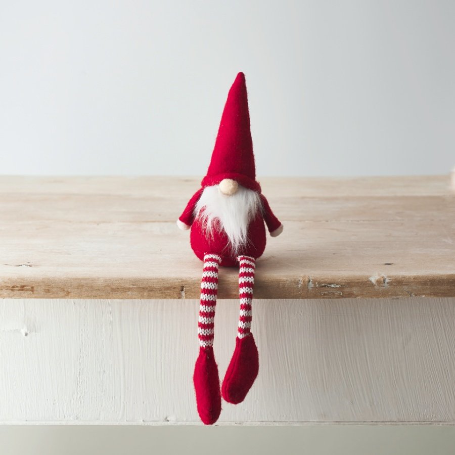   A delightfully festive themed fabric shelf sitting gonk with long dangly legs and a high pointed hat 