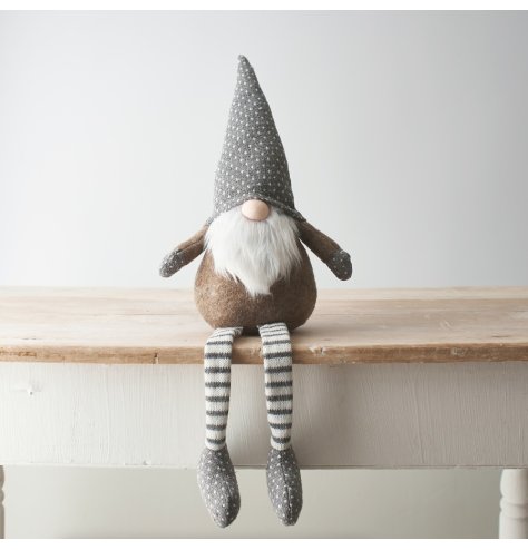 A beige and grey toned fabric shelf sitting gonk, complete with long dangly legs and a fuzzy white beard 