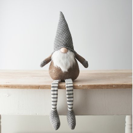 A beige and grey toned fabric shelf sitting gonk, complete with long dangly legs and a fuzzy white beard 