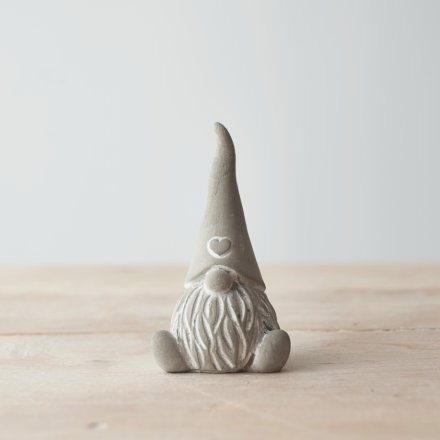 A charming little cement based sitting gonk, decorated with a heart embossed pointed hat 