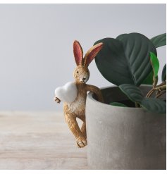 A sweet little pot hanging rabbit with a large white heart decal 