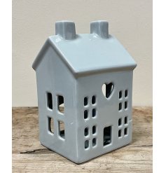 A charming grey ceramic house t-light holder