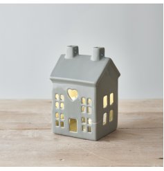A charming grey ceramic house t-light holder