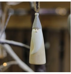 A festive themed hanging gnome with neutral colour tones and a simple string hanger