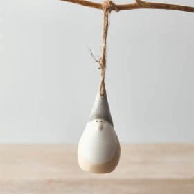 A festive themed hanging gonk with neutral colour tones and a simple string hanger