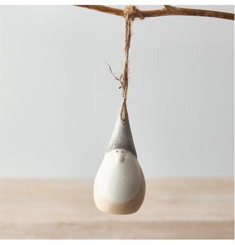 A small hanging ceramic gonk decoration set with a traditional neutral tone and smooth glaze 