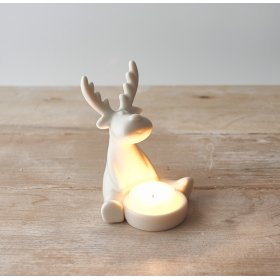 A charming and simple sitting ceramic reindeer complete with a T-light holding space 