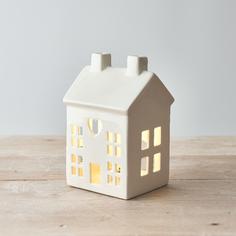 A charming white ceramic house t-light holder