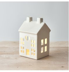 A charming white ceramic house t-light holder