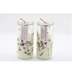 An assortment of tube candles, each decorated with a floral decal and labeled with a scented description 