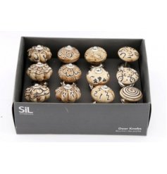 A box of assorted draw knobs with delicate patterns and features to each