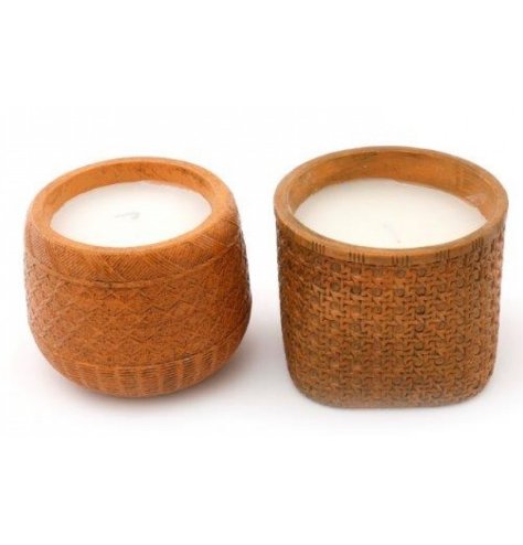 A mix of woven rattan inspired candle pots, each filled with a white wax candle 